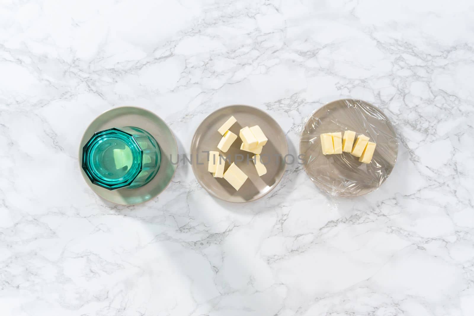 Flat lay. Softened sticks of unsalted butter on the counter.