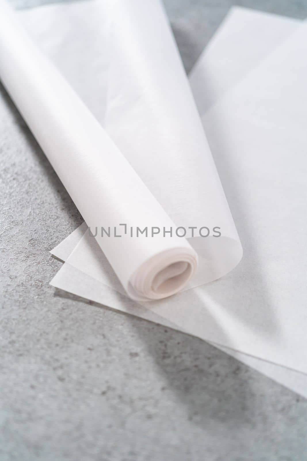 Pre-cut and rolled parchment papers on the kitchen counter.
