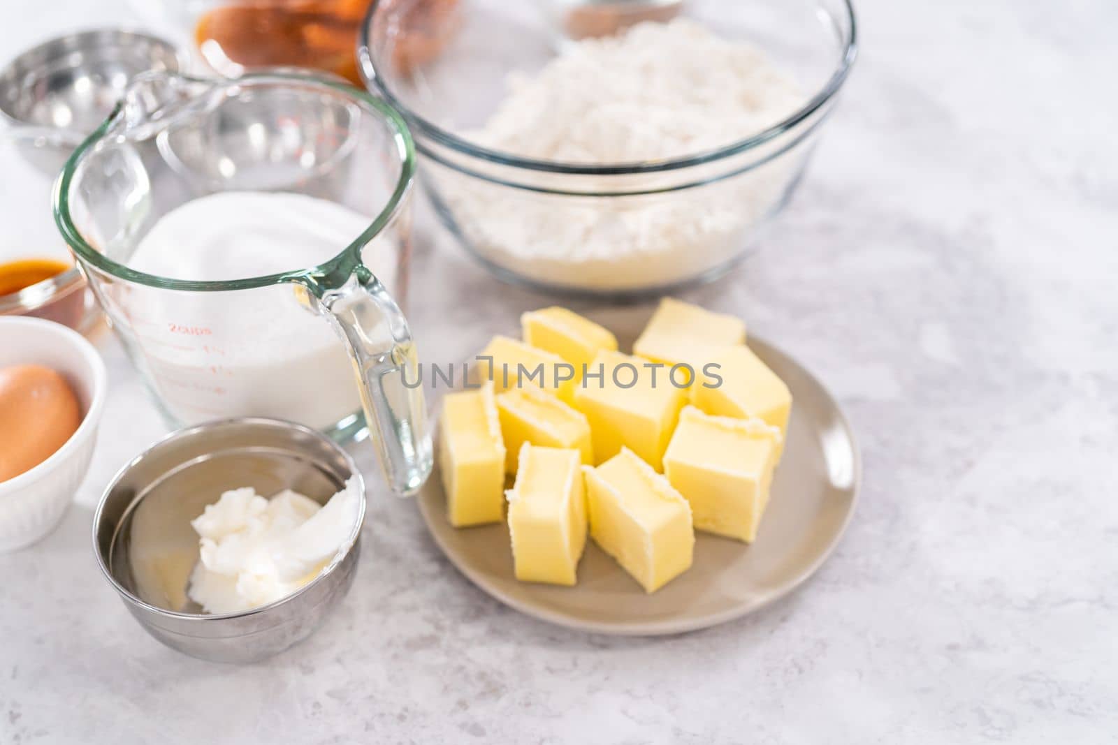 Measured ingredients in a glass mixing bowls to bake sweet pumpkin bread.