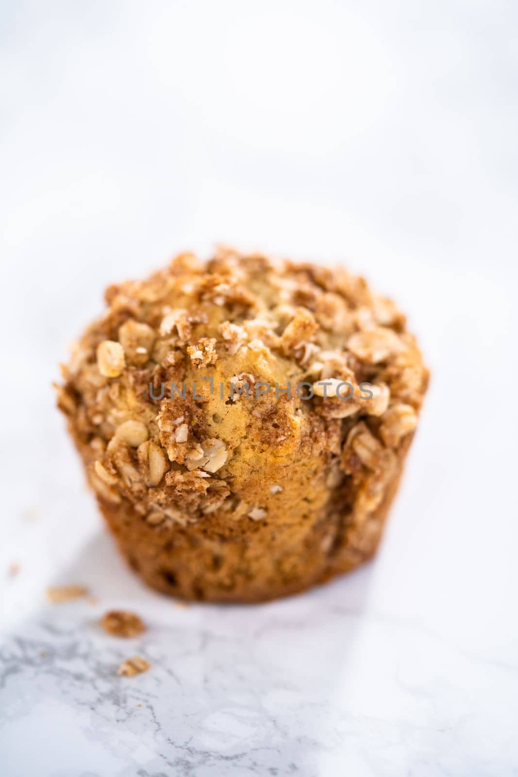 Freshly baked banana oatmeal muffins with oatmeal sugar topping.