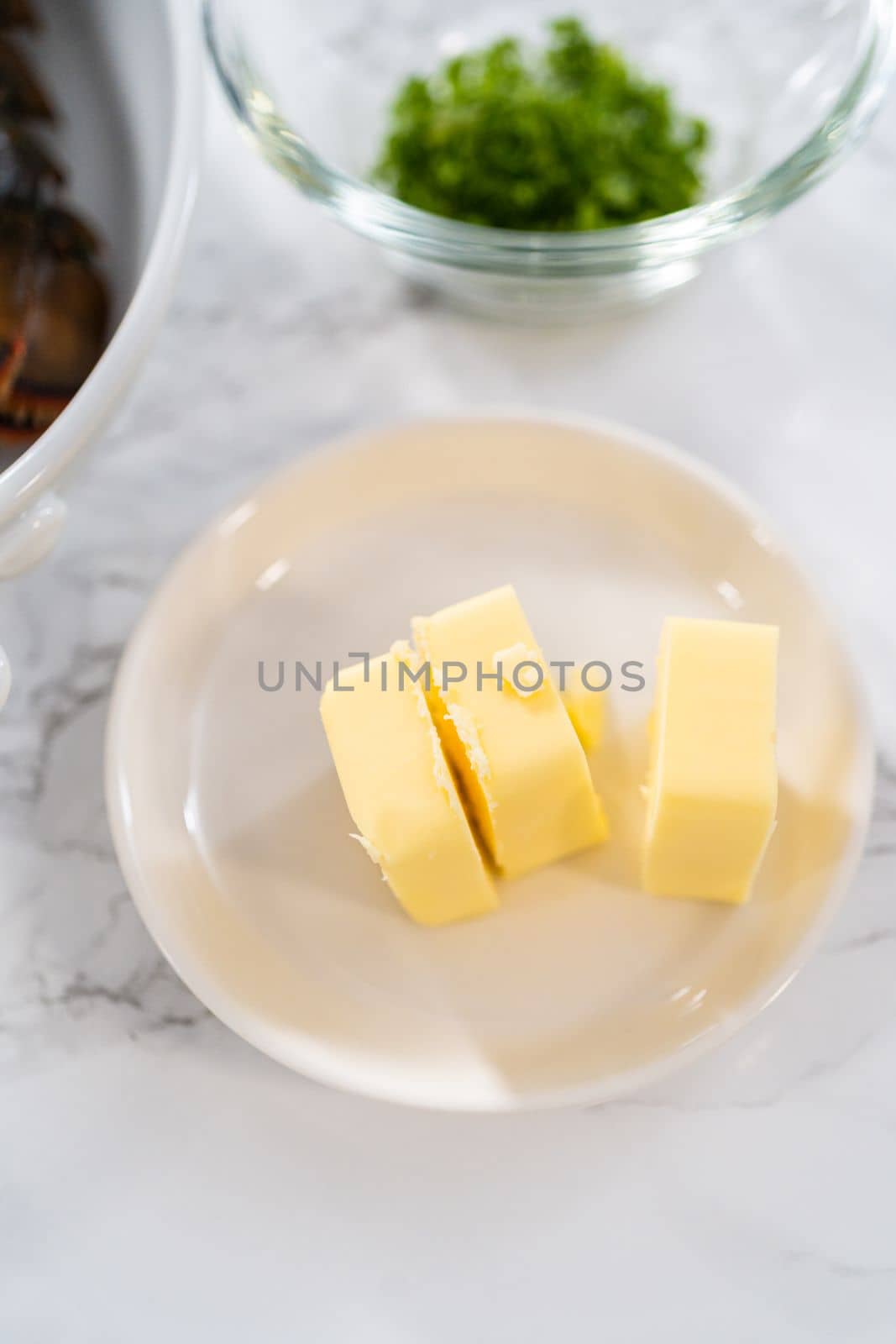 Flat lay. Measured ingredients in glass mixing bowls to prepare garlic lobster tails.