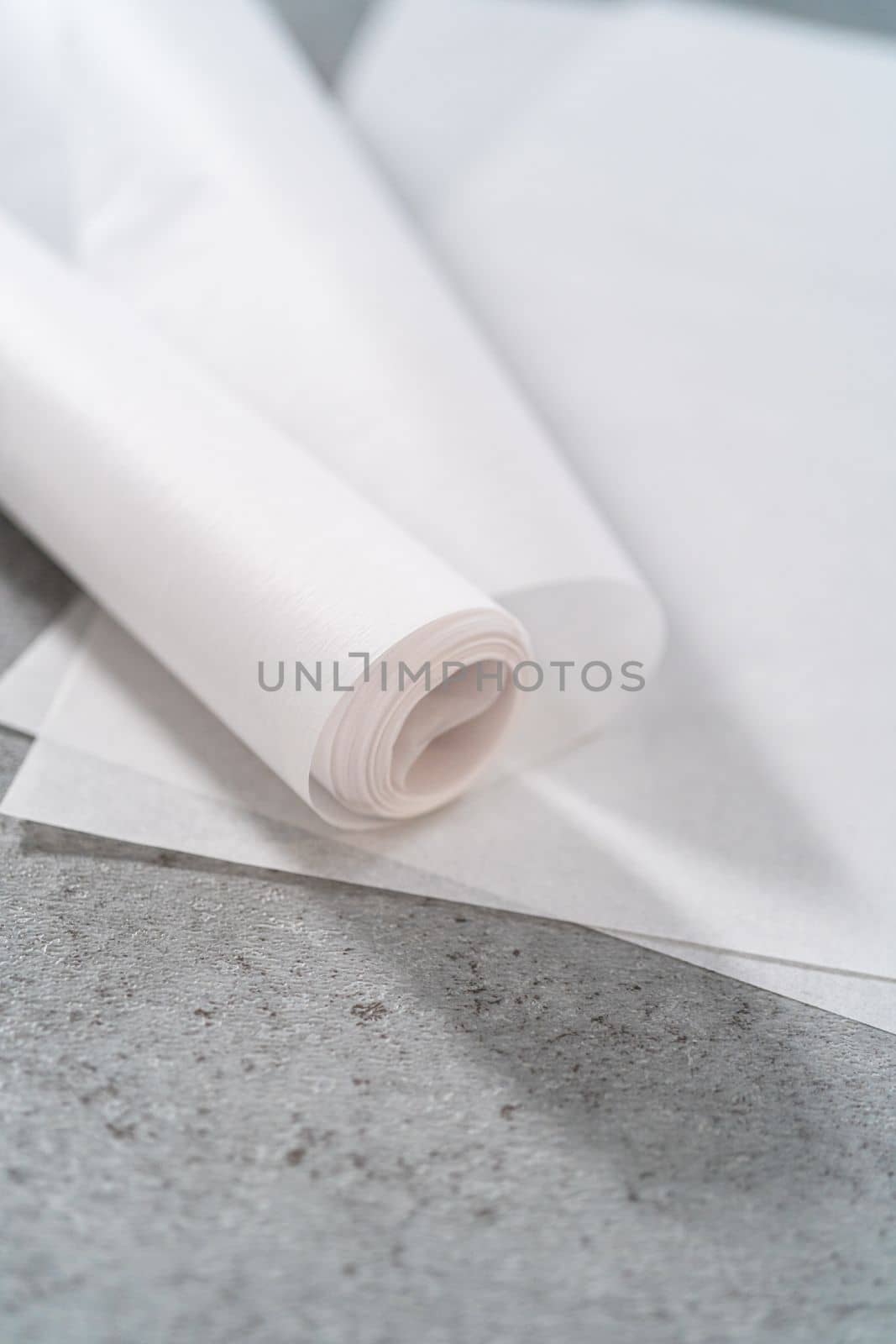 Pre-cut and rolled parchment papers on the kitchen counter.