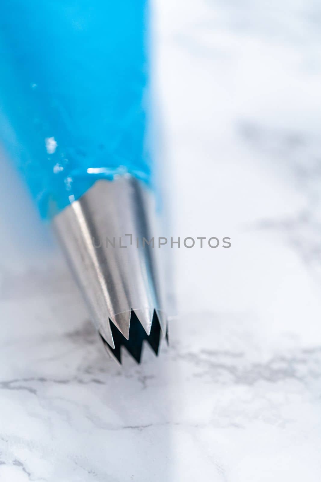 Buttercream frosting in a piping bag for decorating a cake.