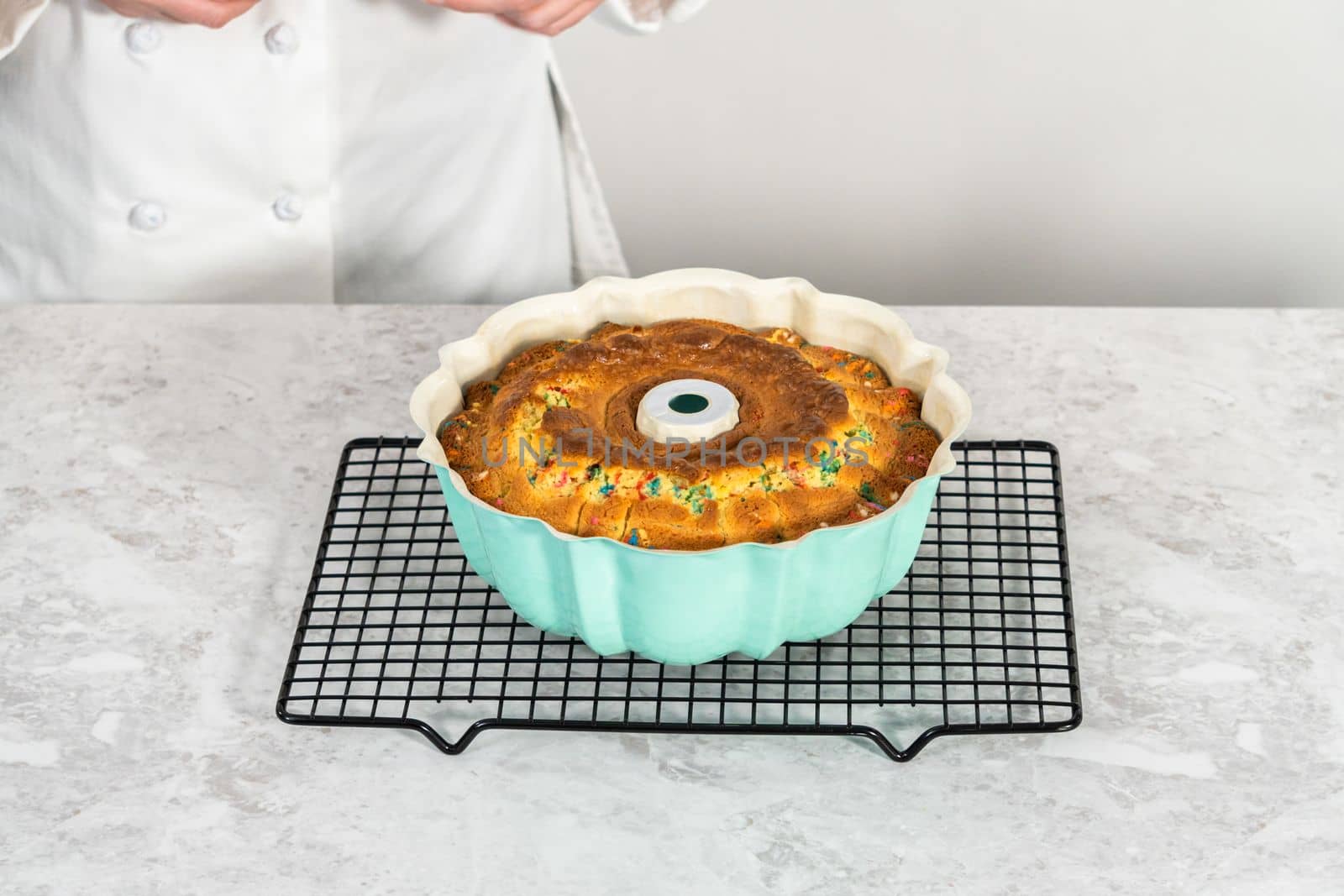 Cooling freshly baked funfettti bundt cake on a wire rack.