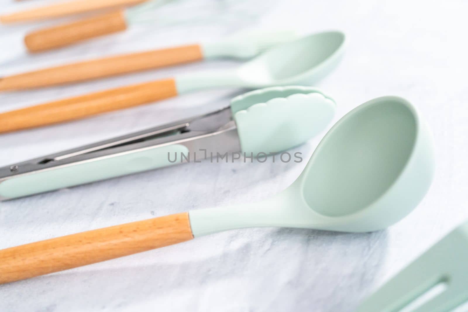 Silicone cooking utensils with wooden handle.