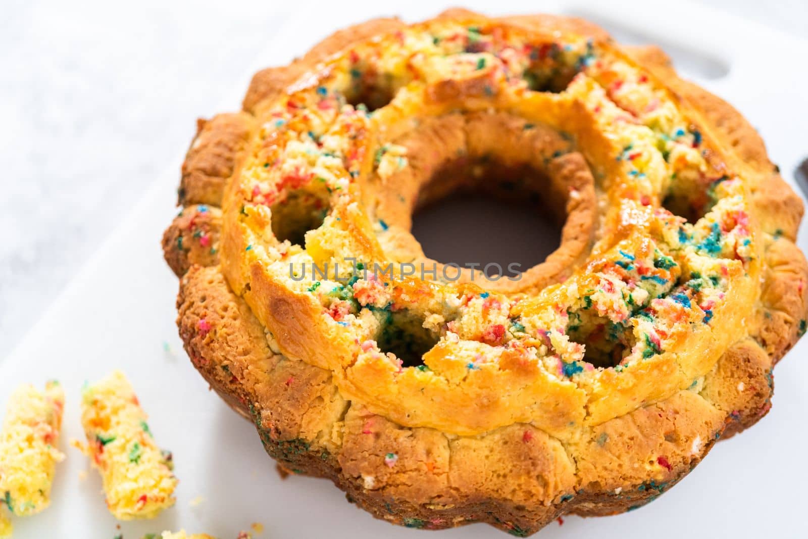 Creating holes for the buttercream filling in funfettti bundt cake.