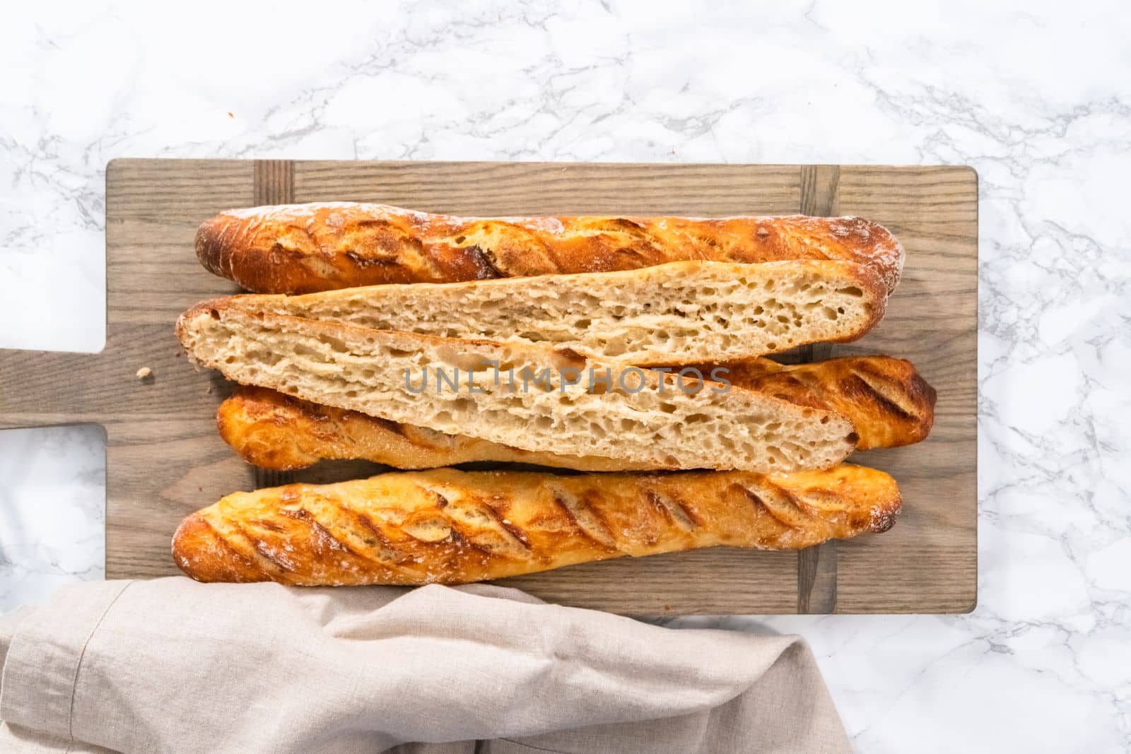 Flat lay. Freshly baked small French baguette bread.