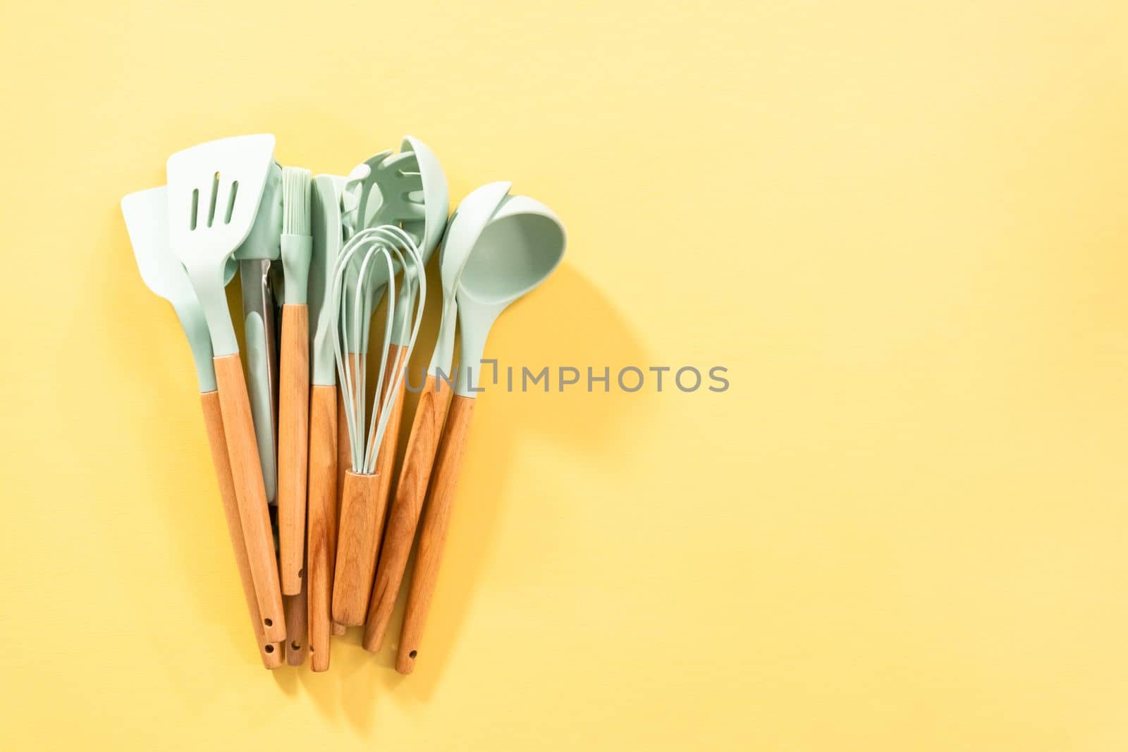 Flat lay. Silicone cooking utensils with wooden handle.
