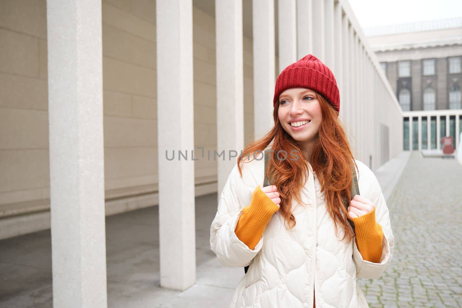 Happy redhead girl, tourist going around town, exploring sighsteeing places in city, backpacking around europe, enjoys travelling by Benzoix