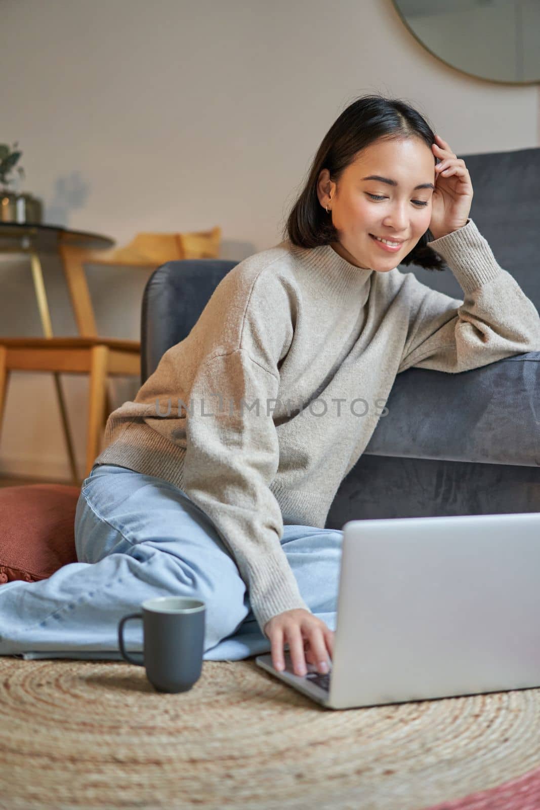 Vertical shot of beautiful asian woman, student sitting at home and studying remotely, elearning with laptop by Benzoix