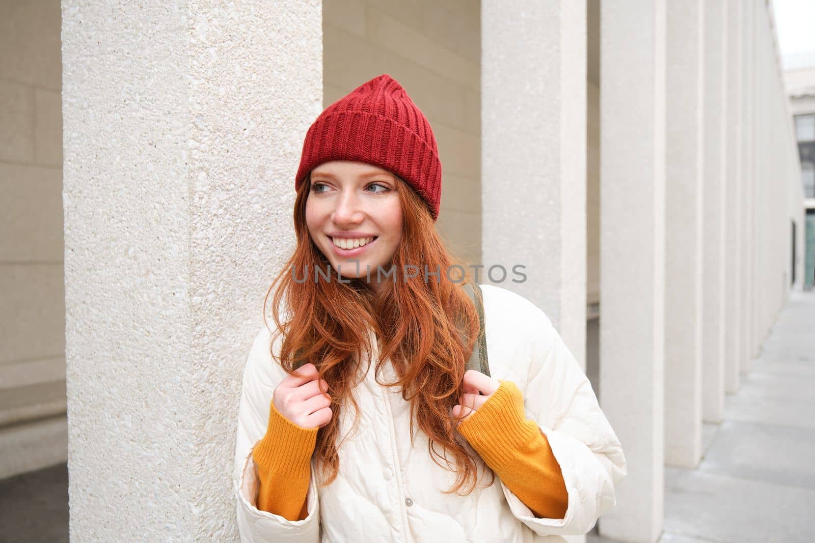 Happy redhead girl, tourist going around town, exploring sighsteeing places in city, backpacking around europe, enjoys travelling.