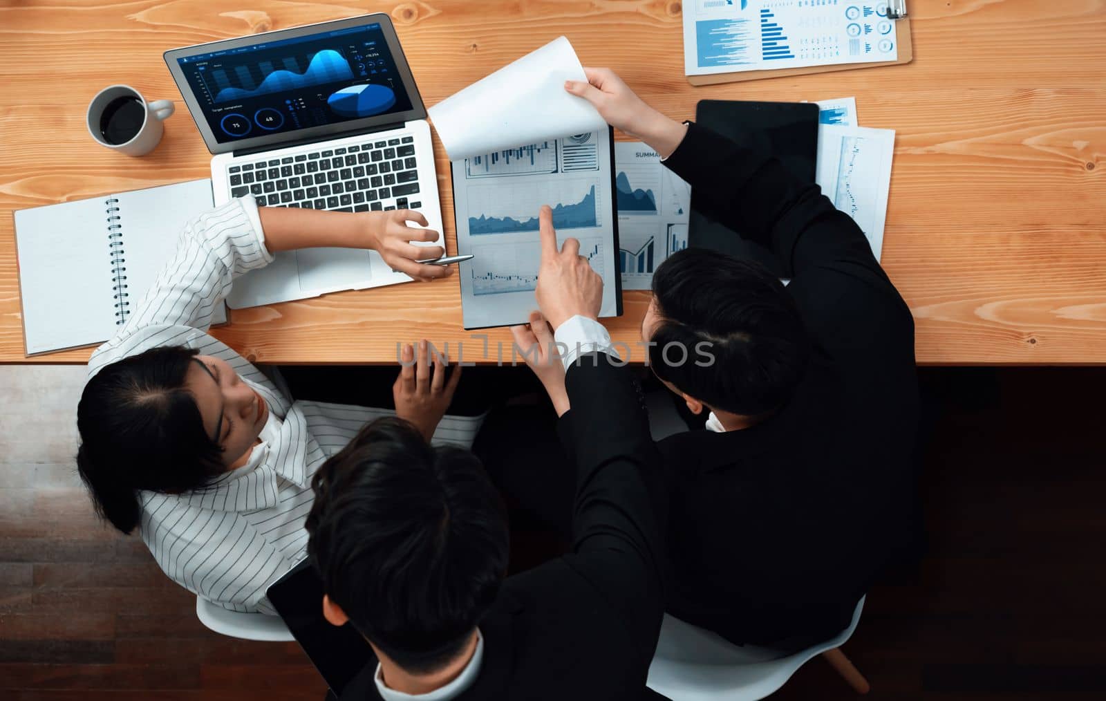 Top-view business team of financial data analysis meeting with business intelligence, report paper and dashboard on laptop for marketing strategy. Business people working together in office of harmony