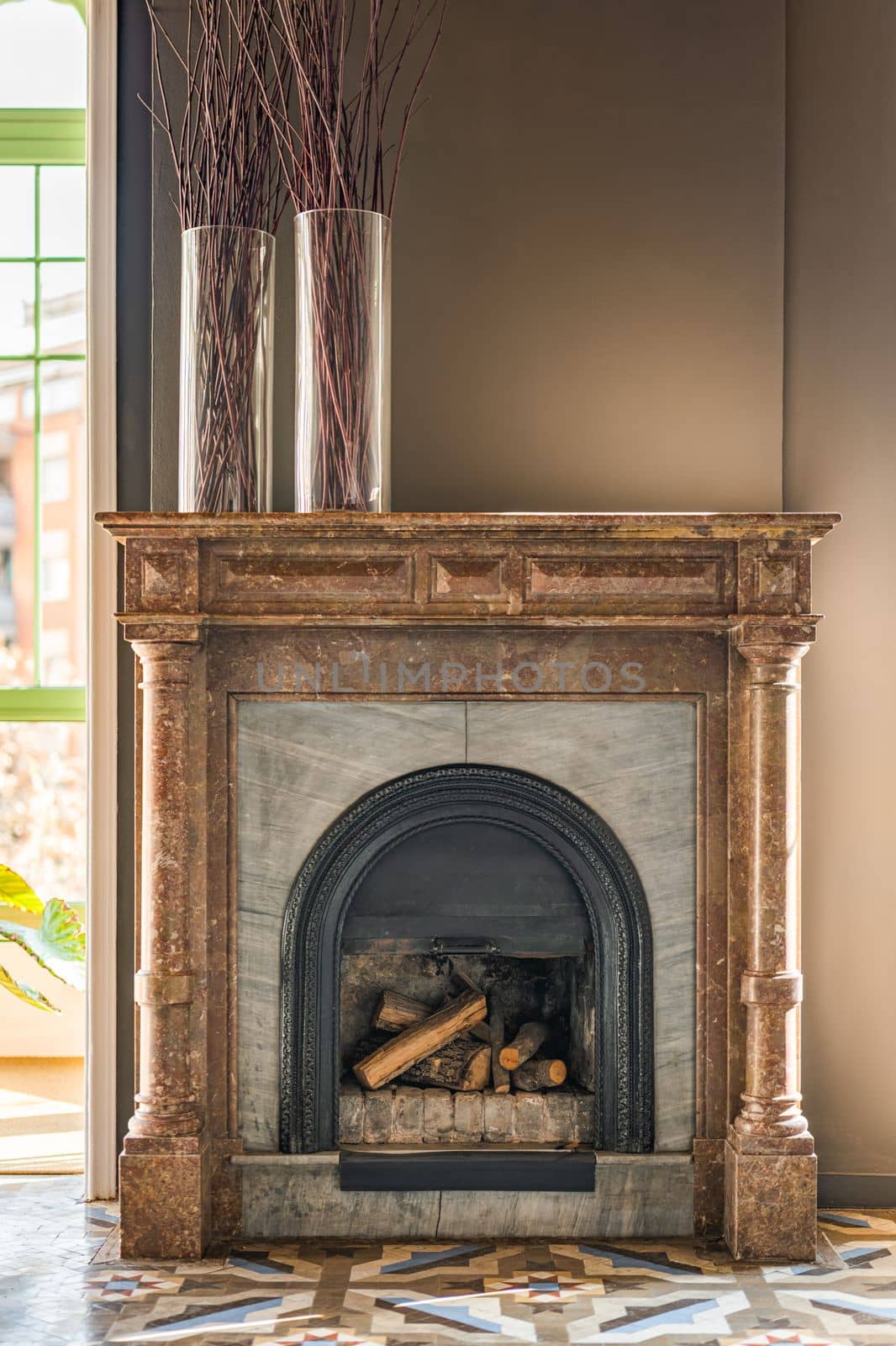 Fireplace made of heat-resistant bricks is lined with marble material of different textures and colors on top creating and majesty with notes of 18th century era. Part of an exclusive interior