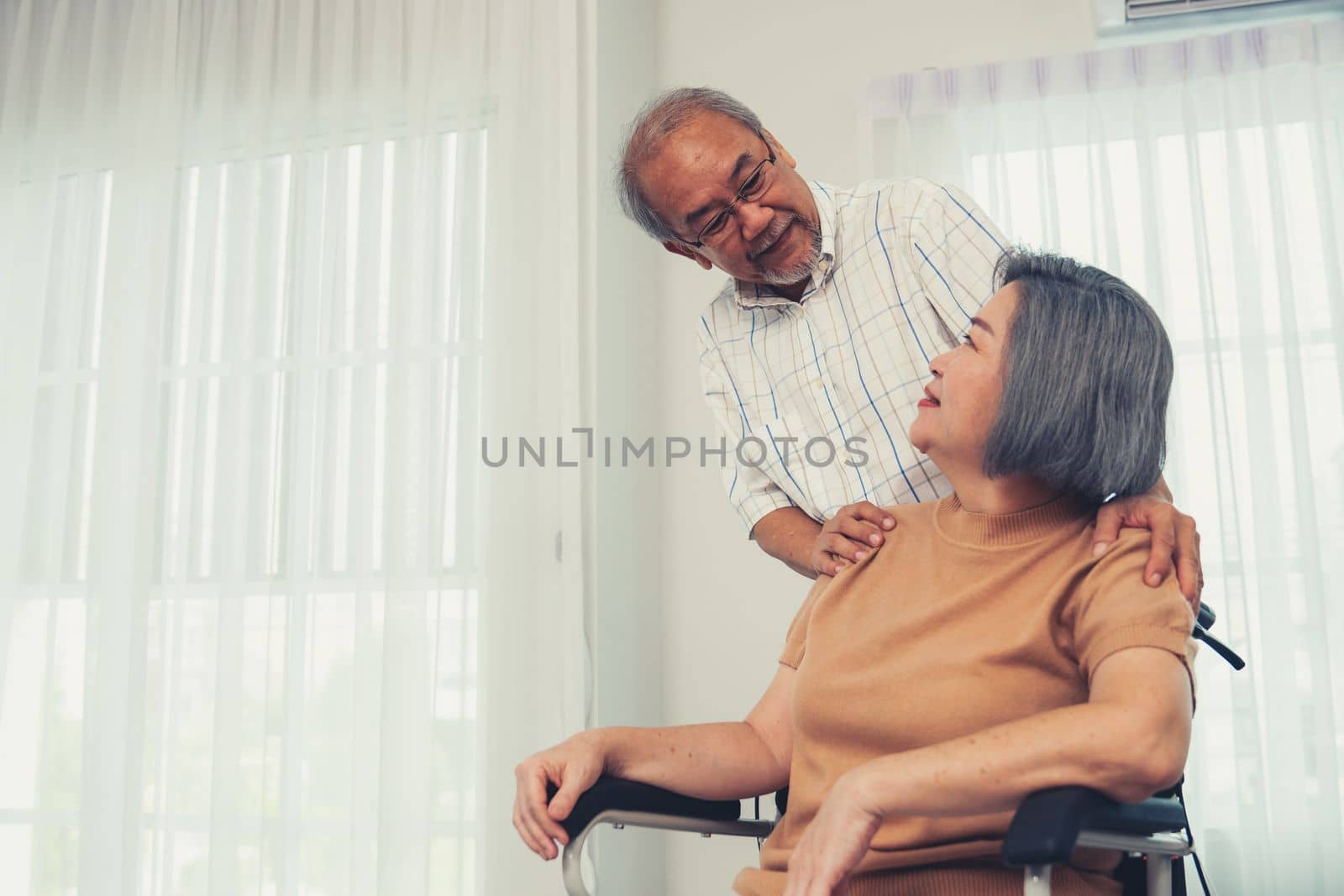 A contented senior couple and their in-home nurse. by biancoblue