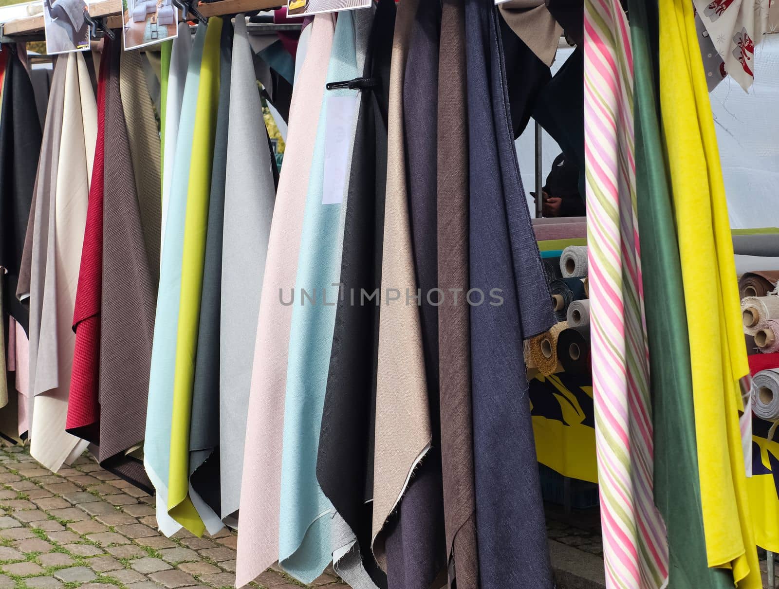 Samples of cloth and fabrics in different colors found at a fabrics market.