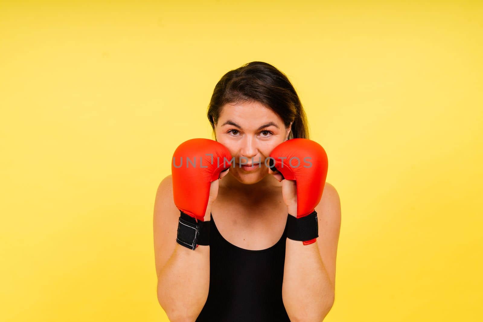 Young woman athletic female MMA fighter is training. Concept of sport, action, healthy lifestyle.