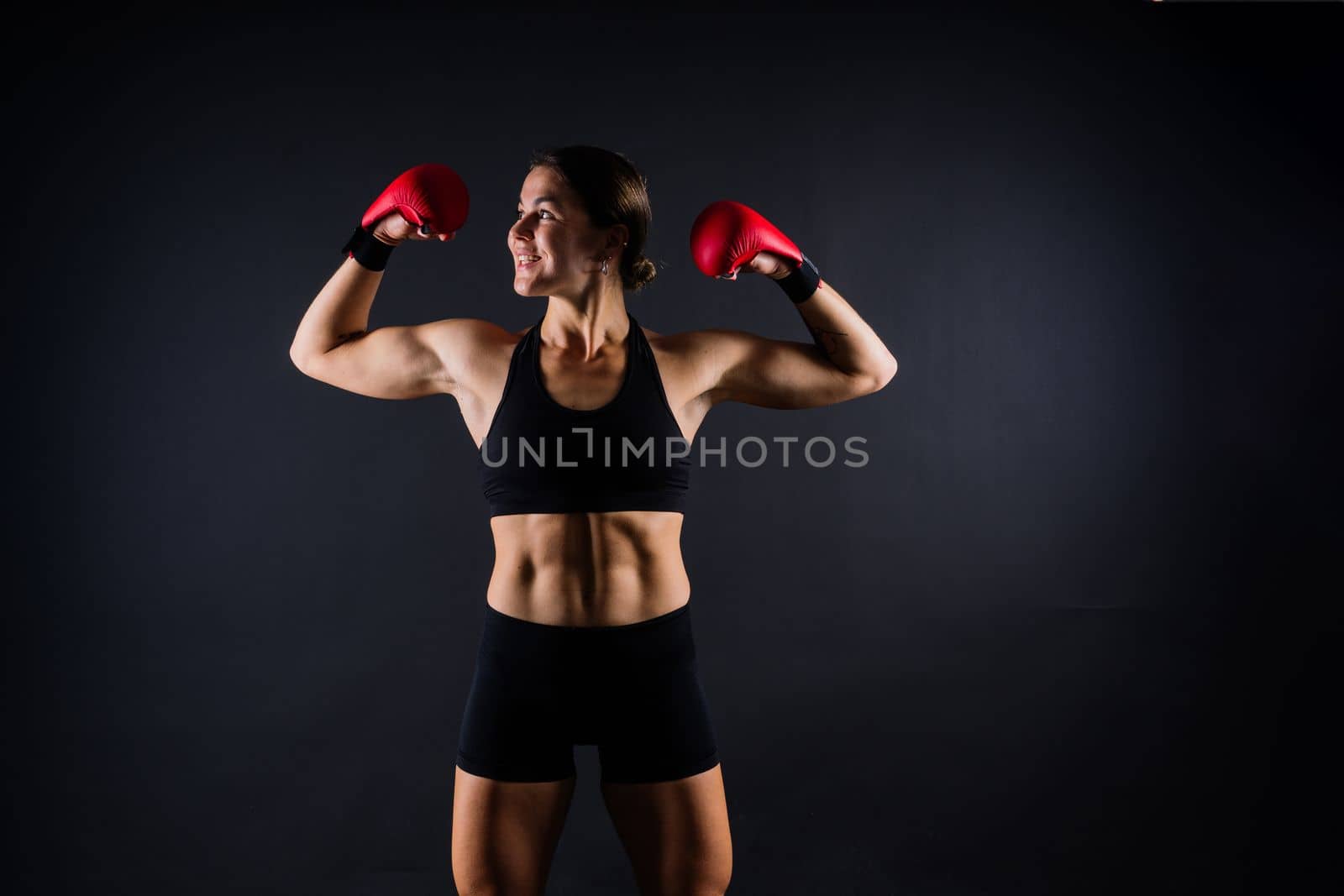 Young woman athletic female MMA fighter training. Concept of sport, action, healthy lifestyle. by Zelenin