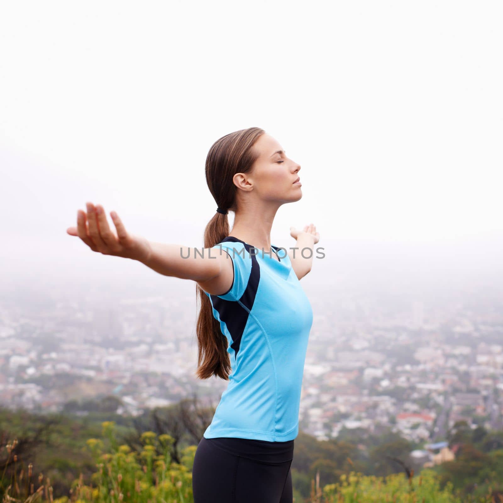Feeling alive. a young woman training outdoors with her arms outstretched