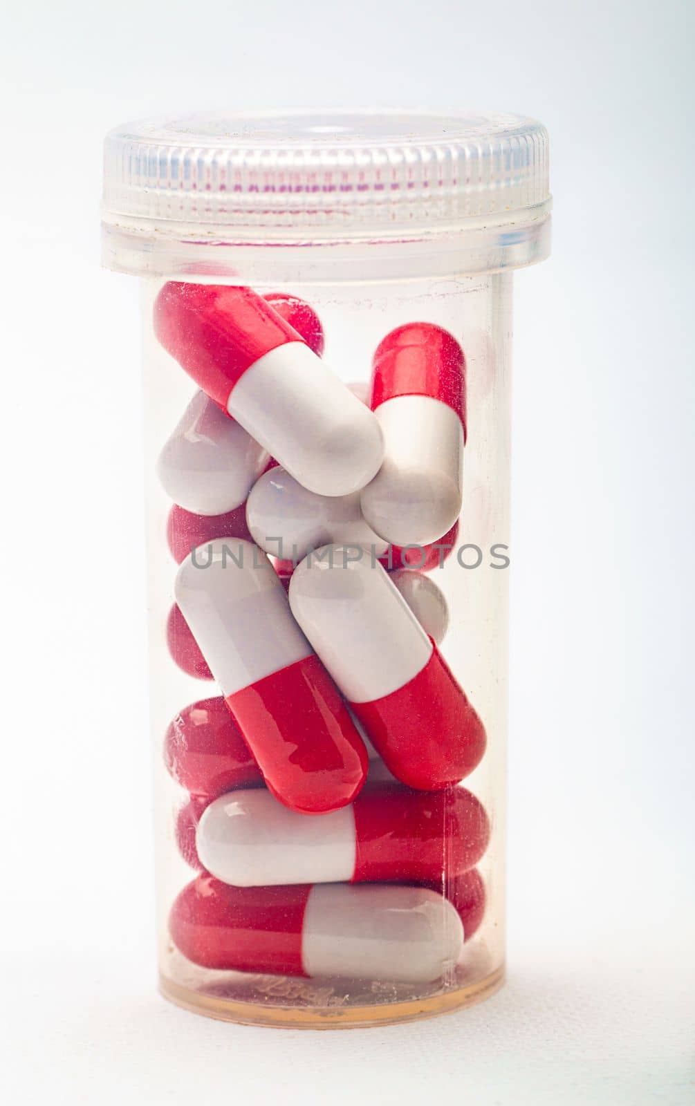 Close up of an isolated bottle of red and white pill