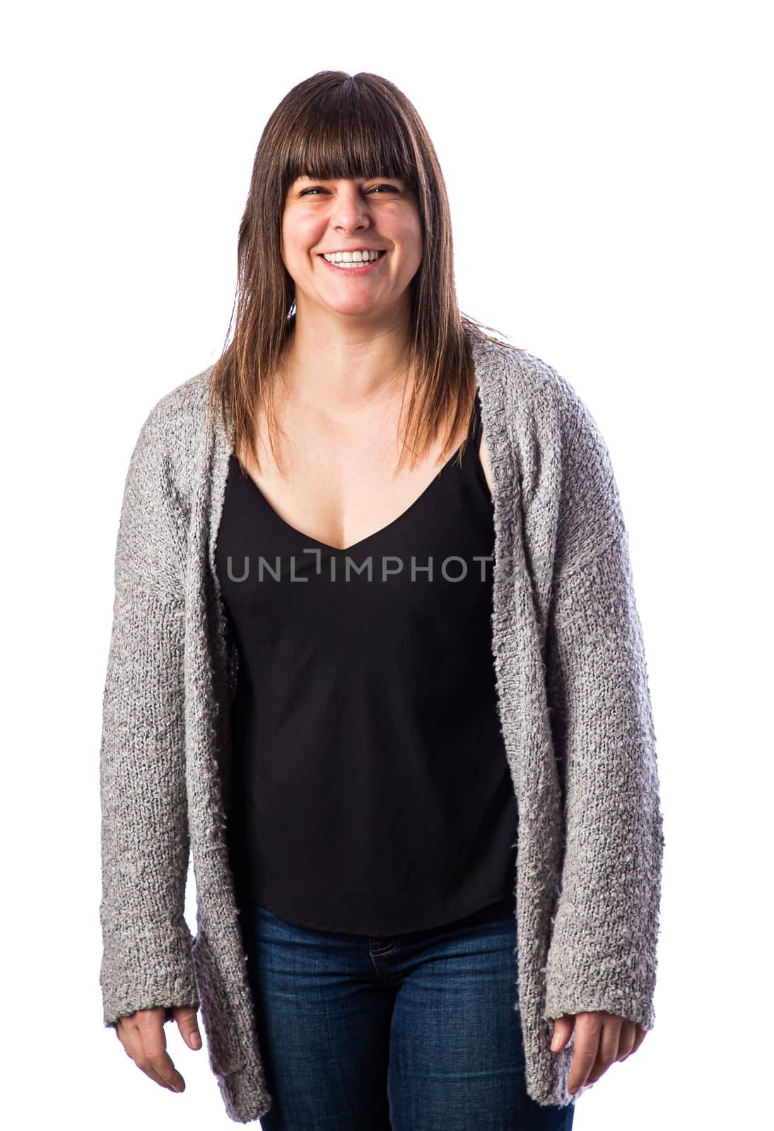 Isolated portrait of a forty year old woman, wearing a gray vest, with a great big smile