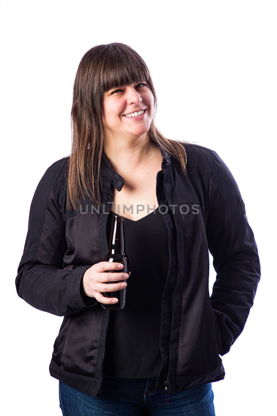 Isolated portrait of a forty year old woman, wearing a biker coat and holding a brown bottle of beer