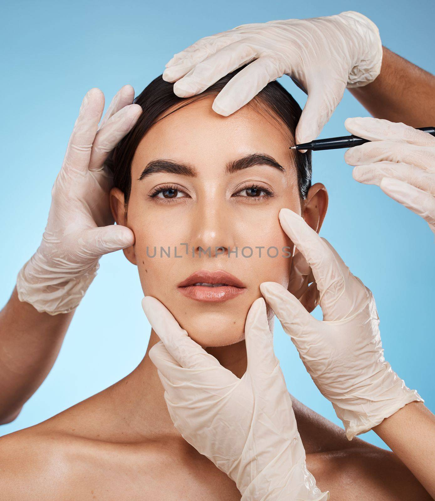 Beauty portrait, woman and plastic surgery hands, isolated on studio background for medical facial and aesthetic. Doctors, medical people for reconstruction or lines with pen on model or person face.