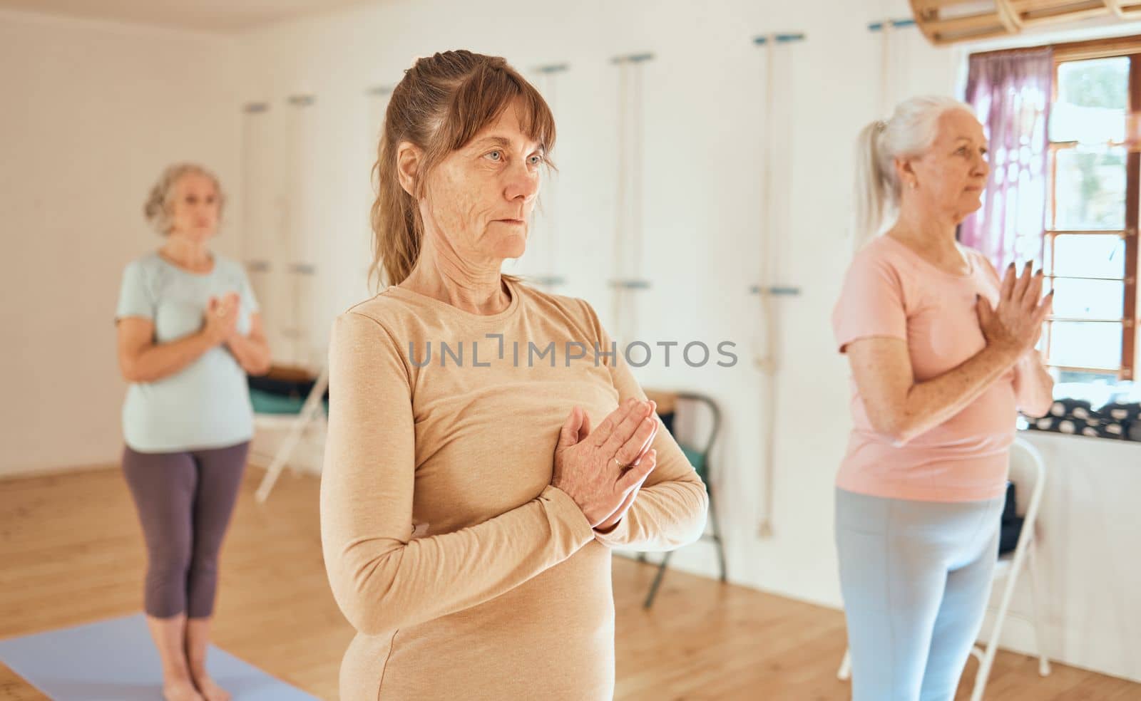 Yoga, relax and retirement wellness class for health, mindfulness and spirituality lesson. Namaste, zen and calm senior women focus together in wellbeing club for a healthy mind and body