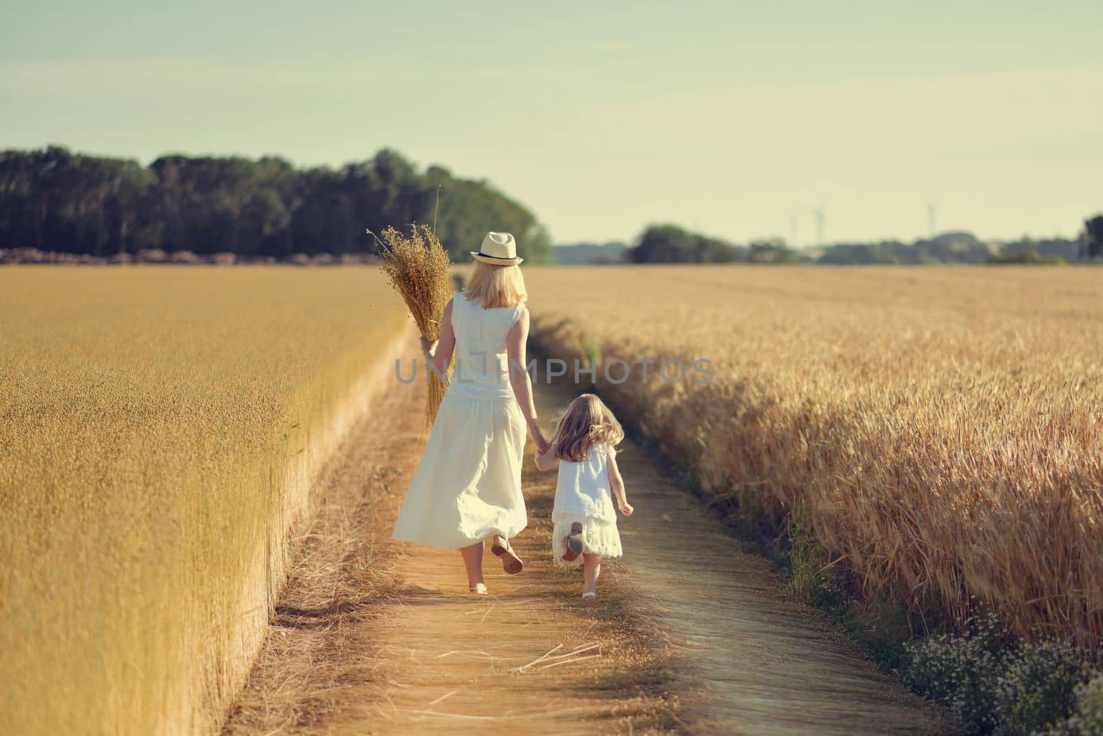 Mother and daughter in the field while harvesting flax Dry linen