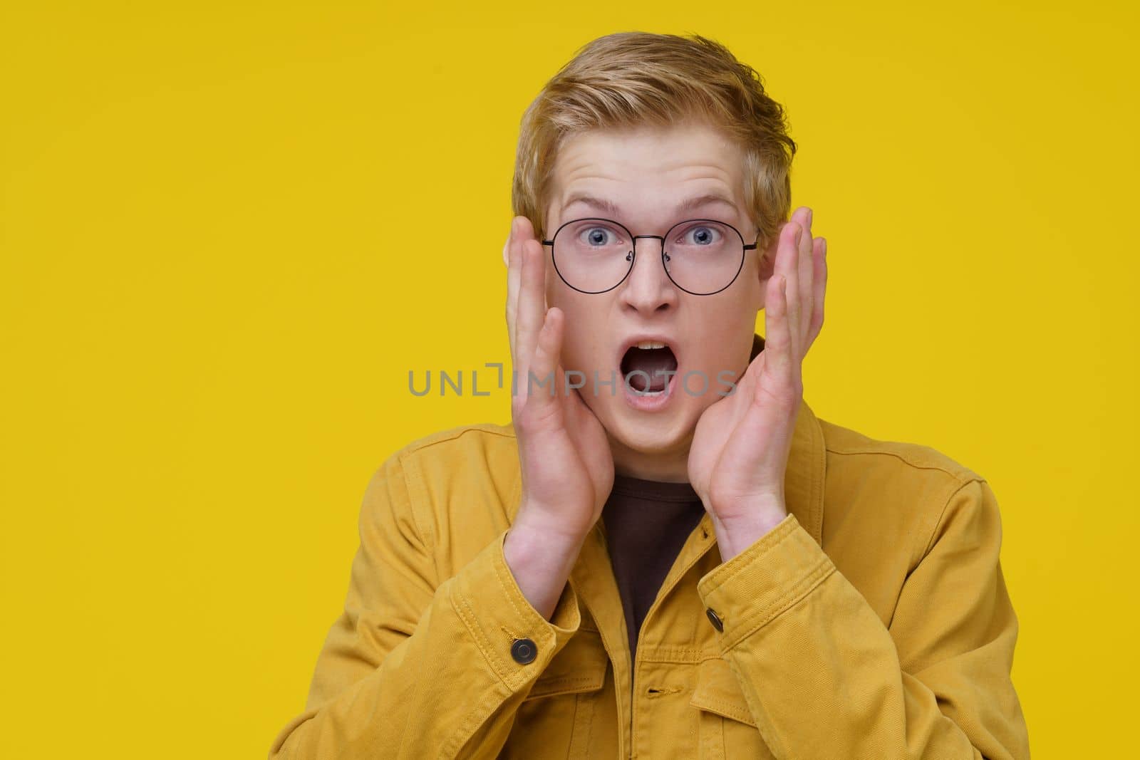 Scary Movie Concept. A Young European Actor Demonstrates a scene from a Cult Movie. by LipikStockMedia