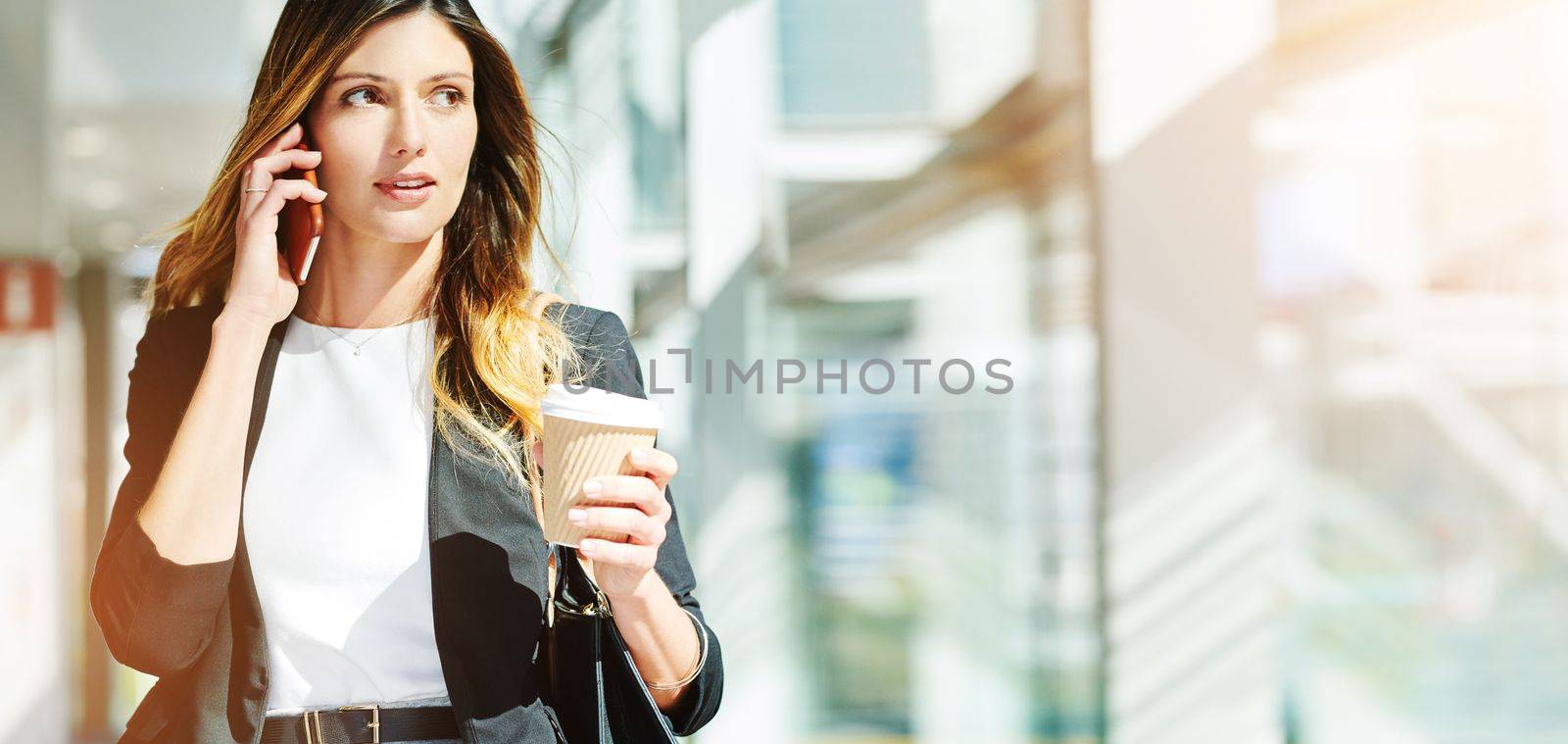 Morning, coffee and woman speaking on a phone call, communication and networking on a mobile. Walking, business and thinking corporate employee talking on a cellphone with a drink in an office.