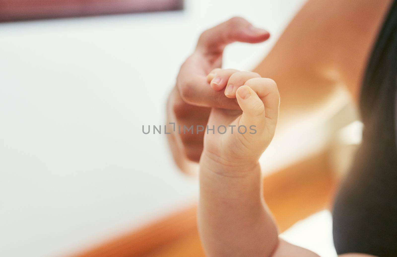 The touch of an unbreakable love. an unreceognizable mother and her baby at home