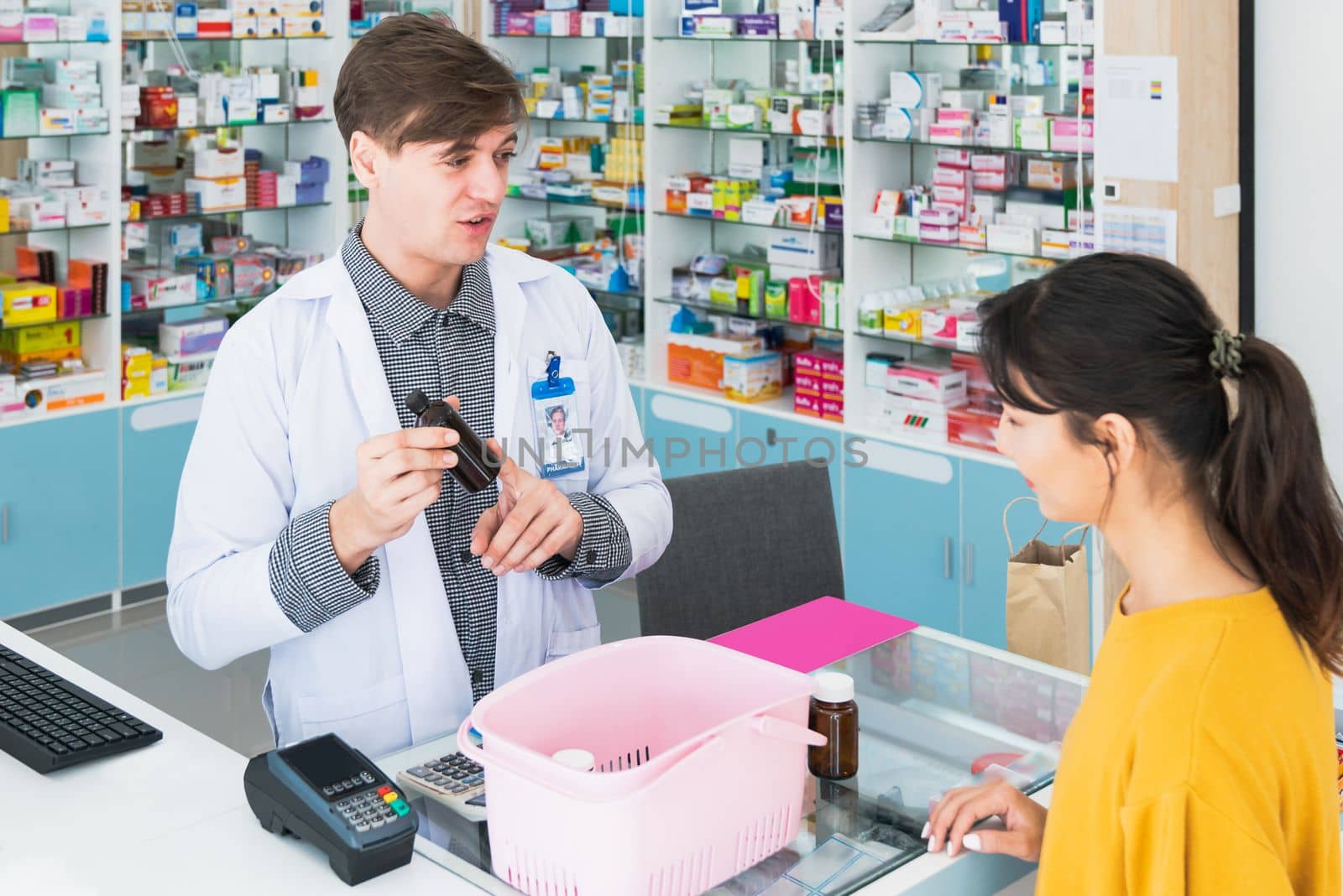 Professional pharmacist advise or explain property of qualified medical product to customer in pharmacy, druggist answer to client healthcare inquiry, medical service and consultation concept.