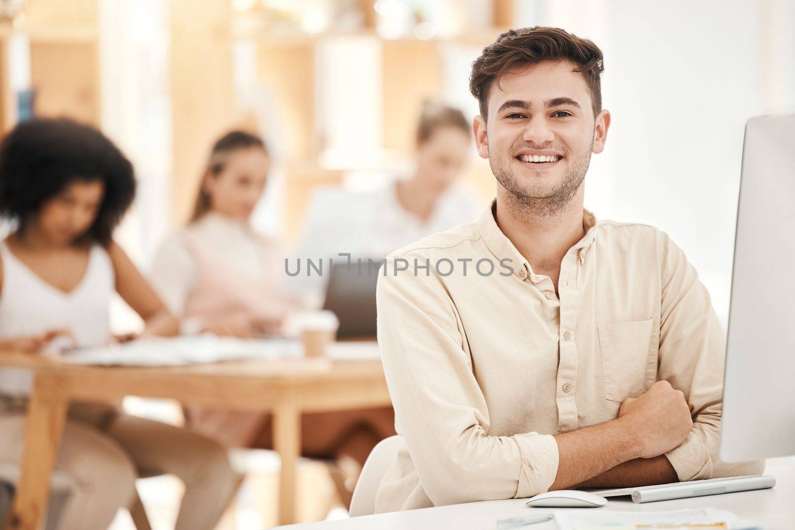 Smile, portrait and businessman working on a computer for marketing, communication and corporate at work. Happy, startup and young worker in connection on technology in a coworking office with mockup.