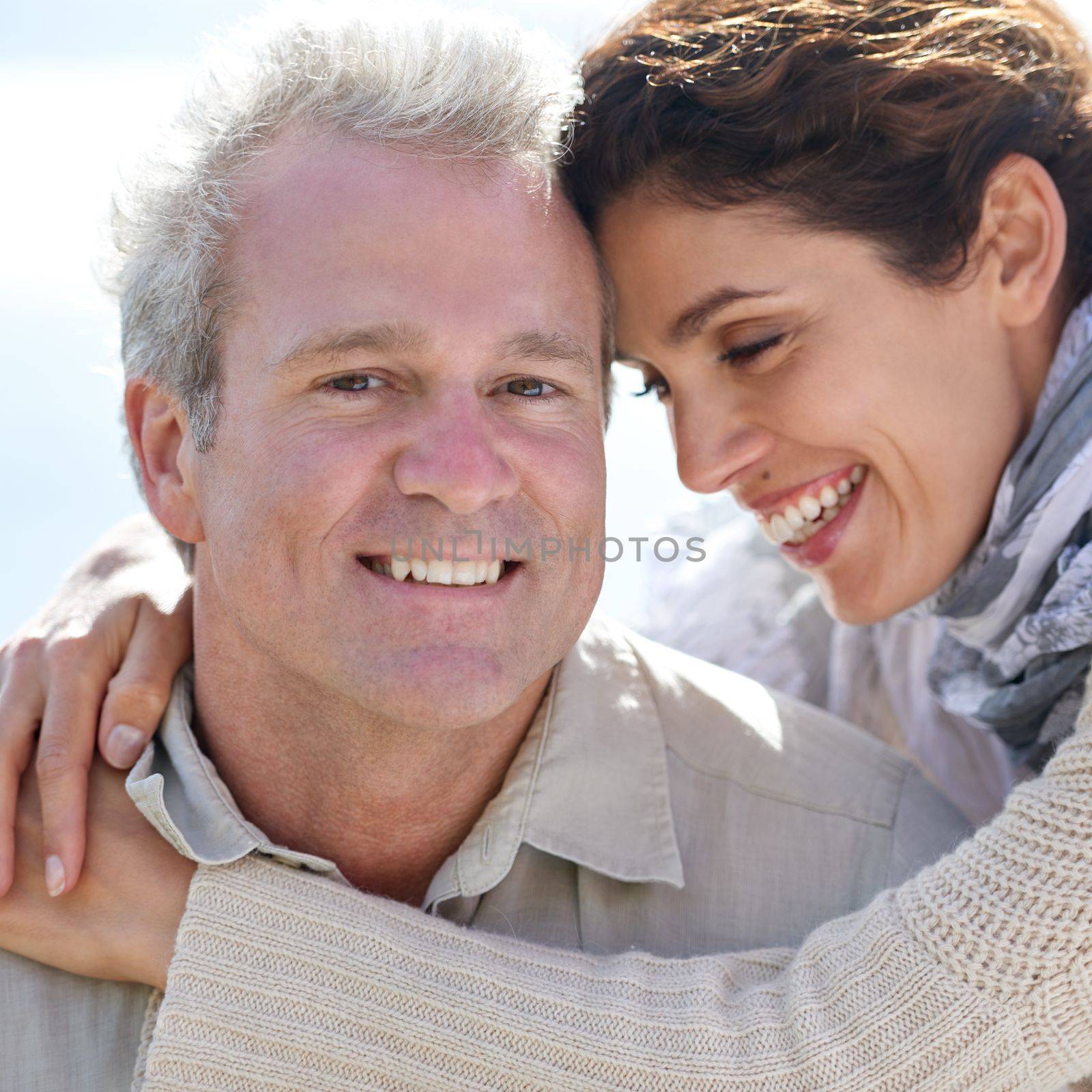 True love. A happy mature couple with their heads together affectionately. by YuriArcurs