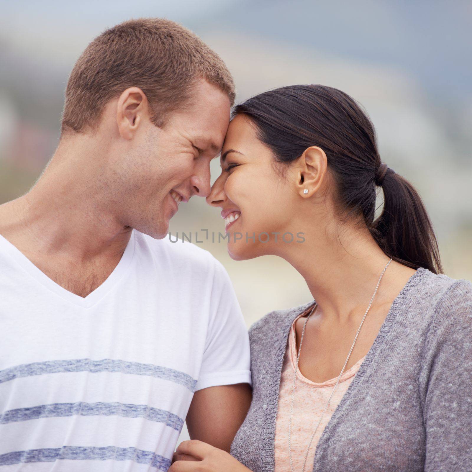 True love and happiness. a loving young couple at the beach. by YuriArcurs