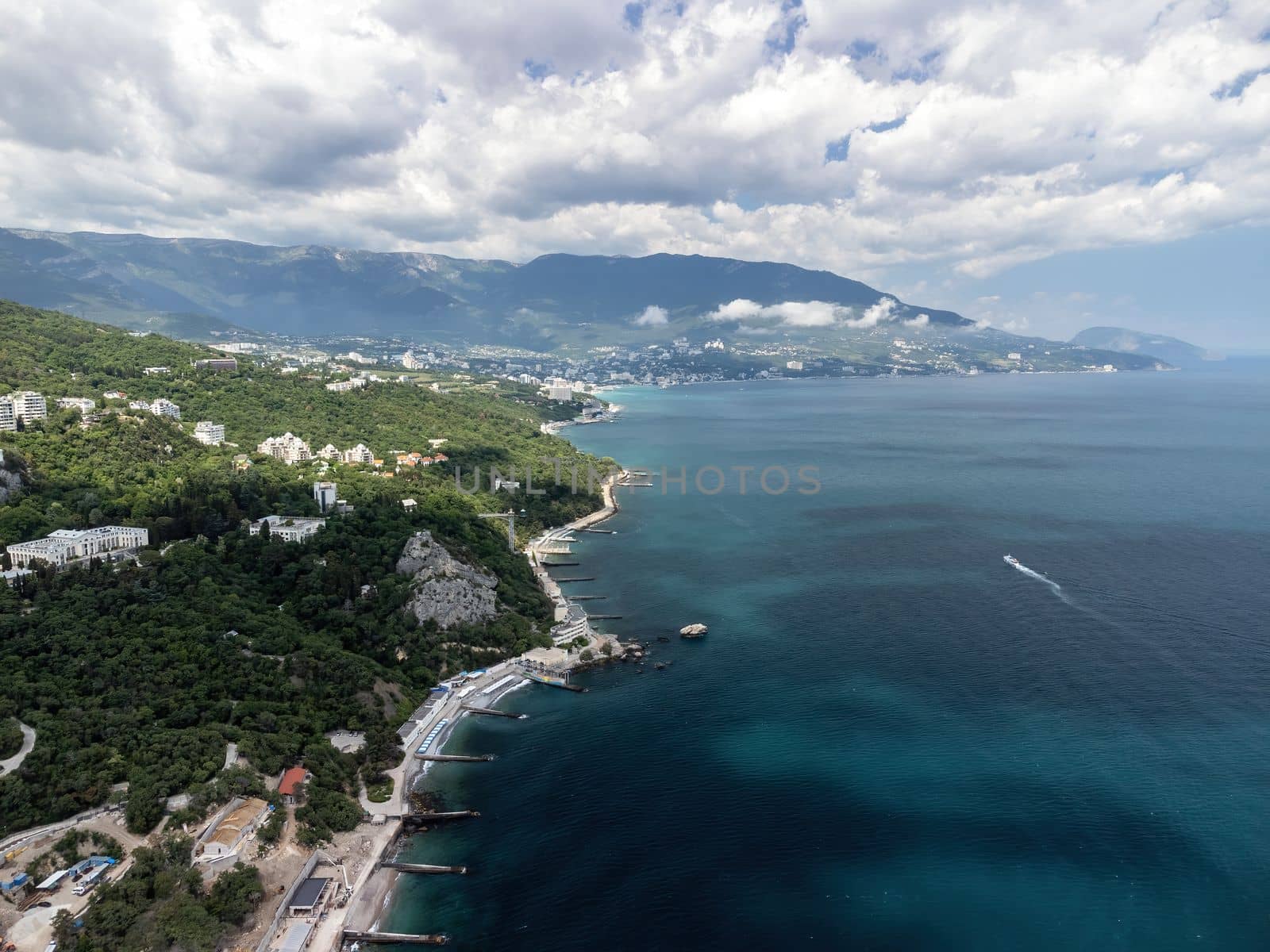 Christian church on a background of mountains. Temple of the Holy Archangel Michael in Oreanda. The southern coast of Crimea. Located on a rocky cliff and is surrounded by beautiful vegetation