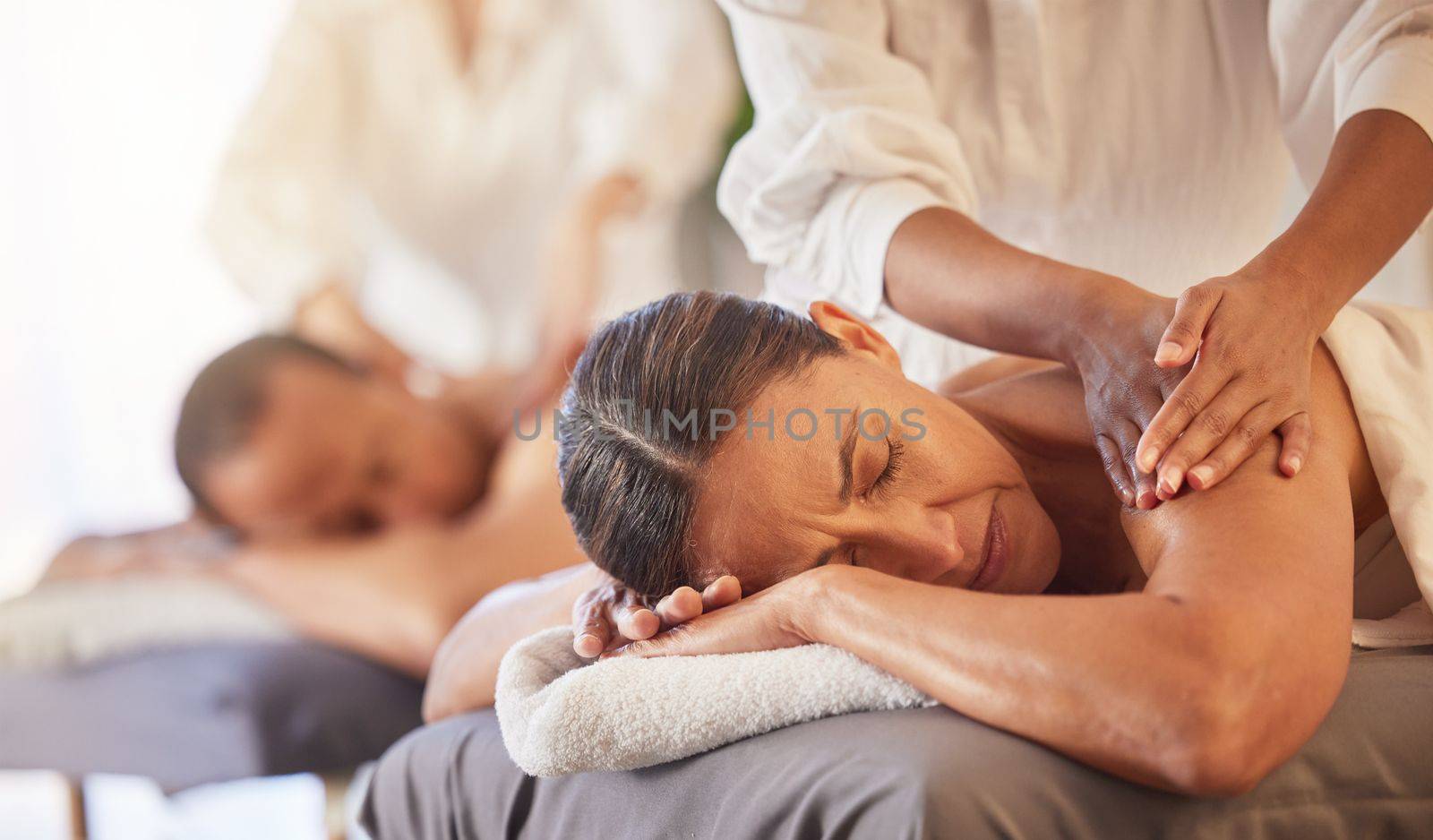 Massage, relax and peace with couple in spa for healing, health and zen treatment. Detox, skincare and beauty with hands of massage therapist on man and woman for calm, physical therapy and luxury.