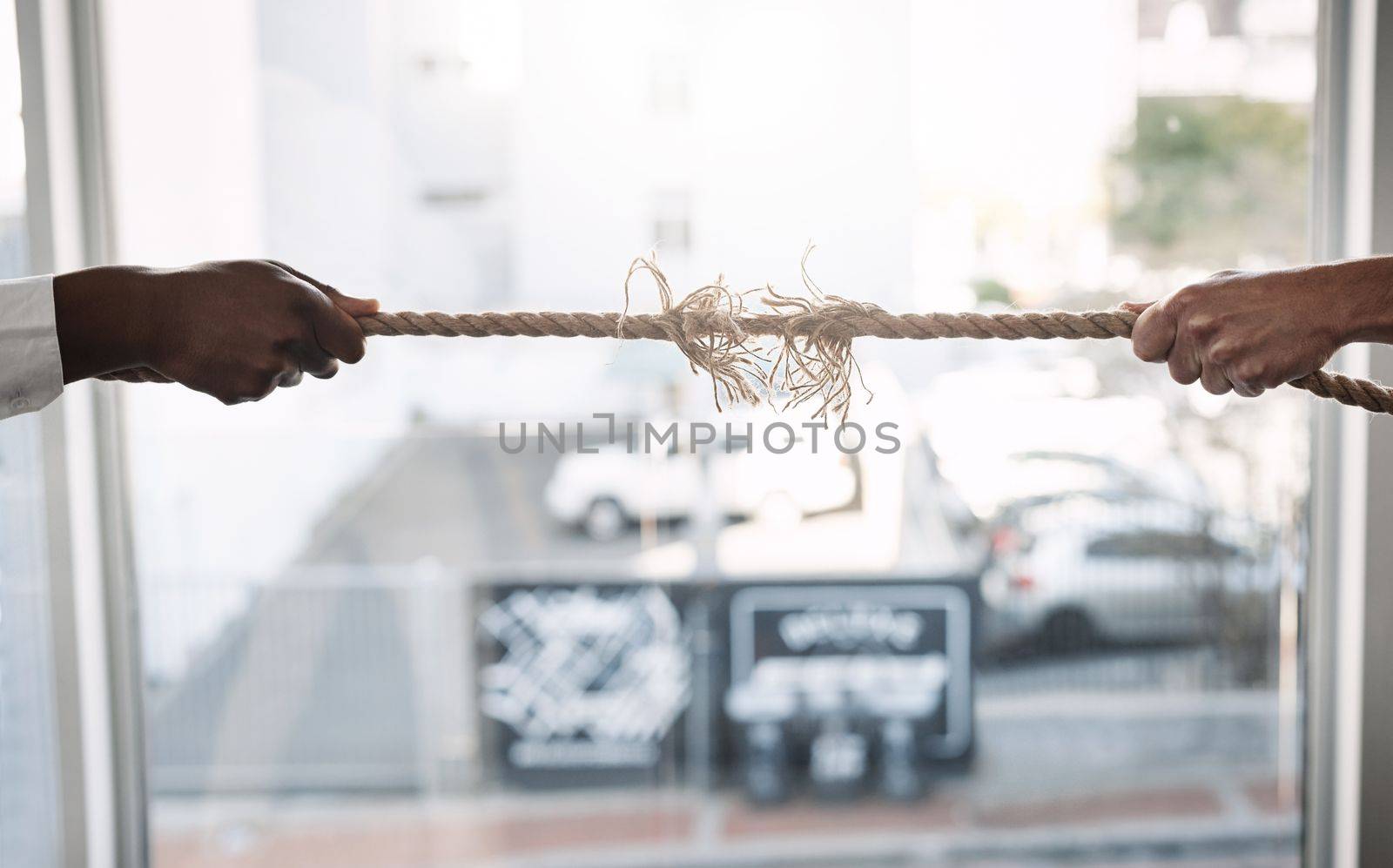 Trying to succeed in a competitive market. unrecognizable businesspeople pulling on a rope during tug of war. by YuriArcurs