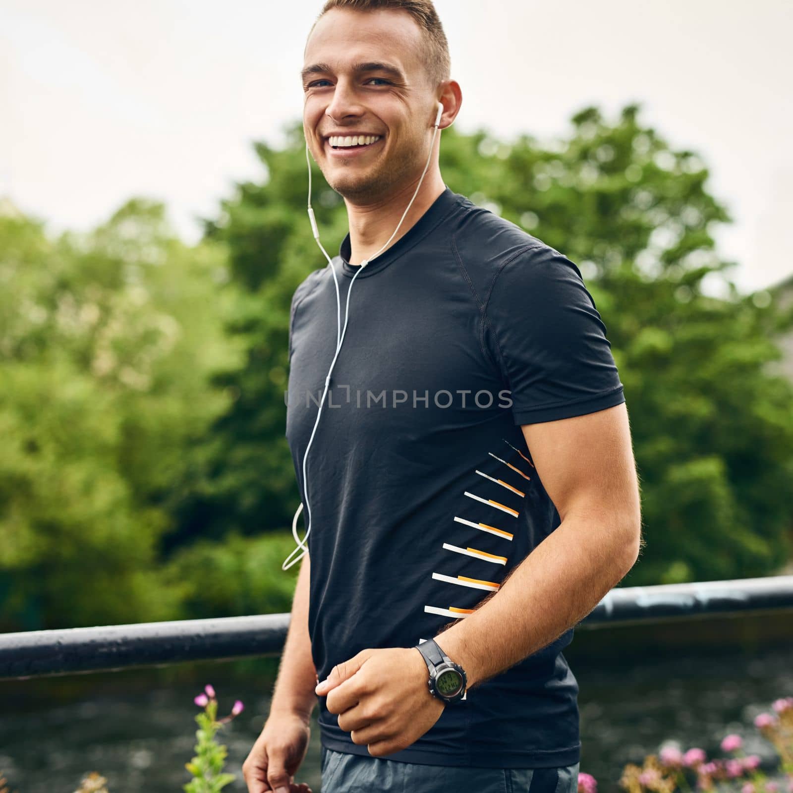 Come on, keep up with me. Portrait of a sporty young man exercising outdoors. by YuriArcurs