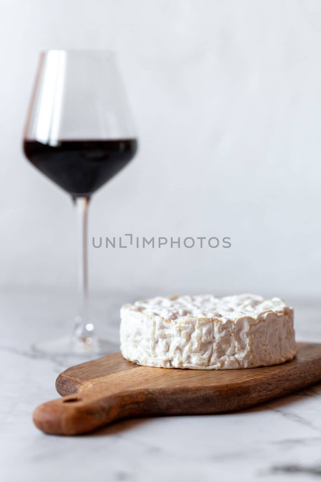 camembert soft cheese served with a glass of red wine