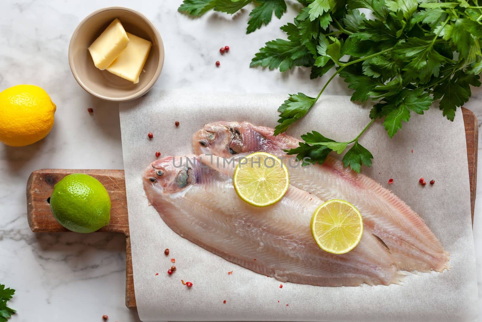 raw sole flatfish ready to be cooked meuniere style, french traditional recipe, top view