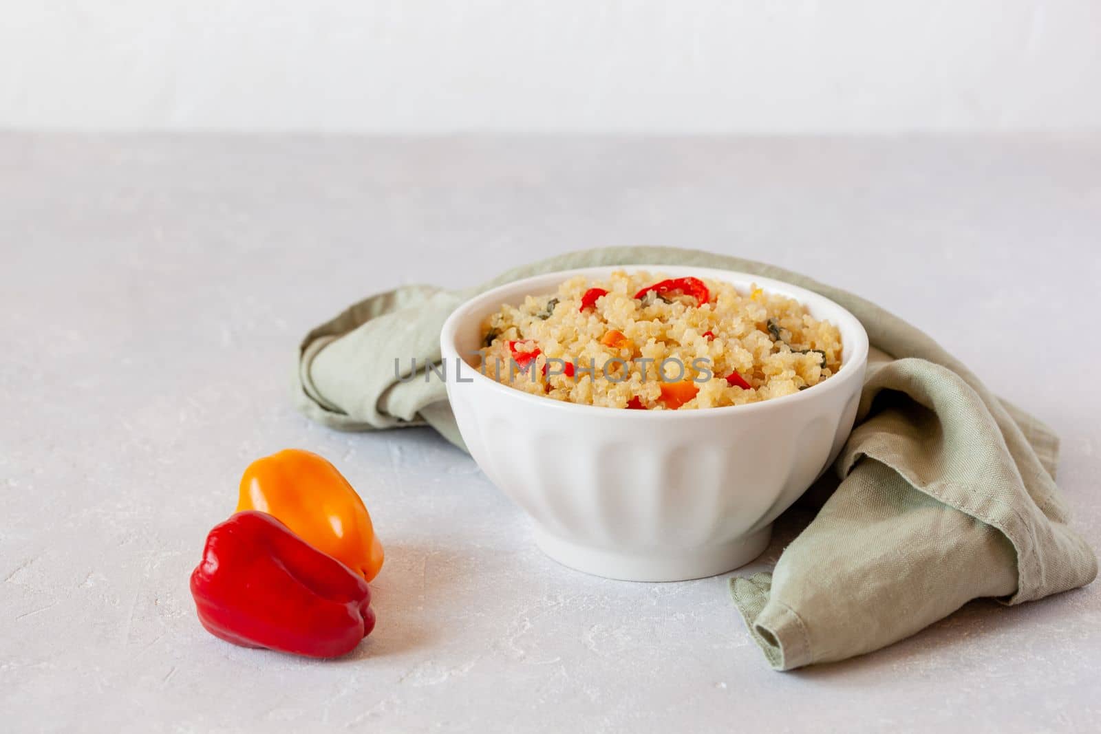 portion of gluten free quinoa cooked with bell peppers, side view