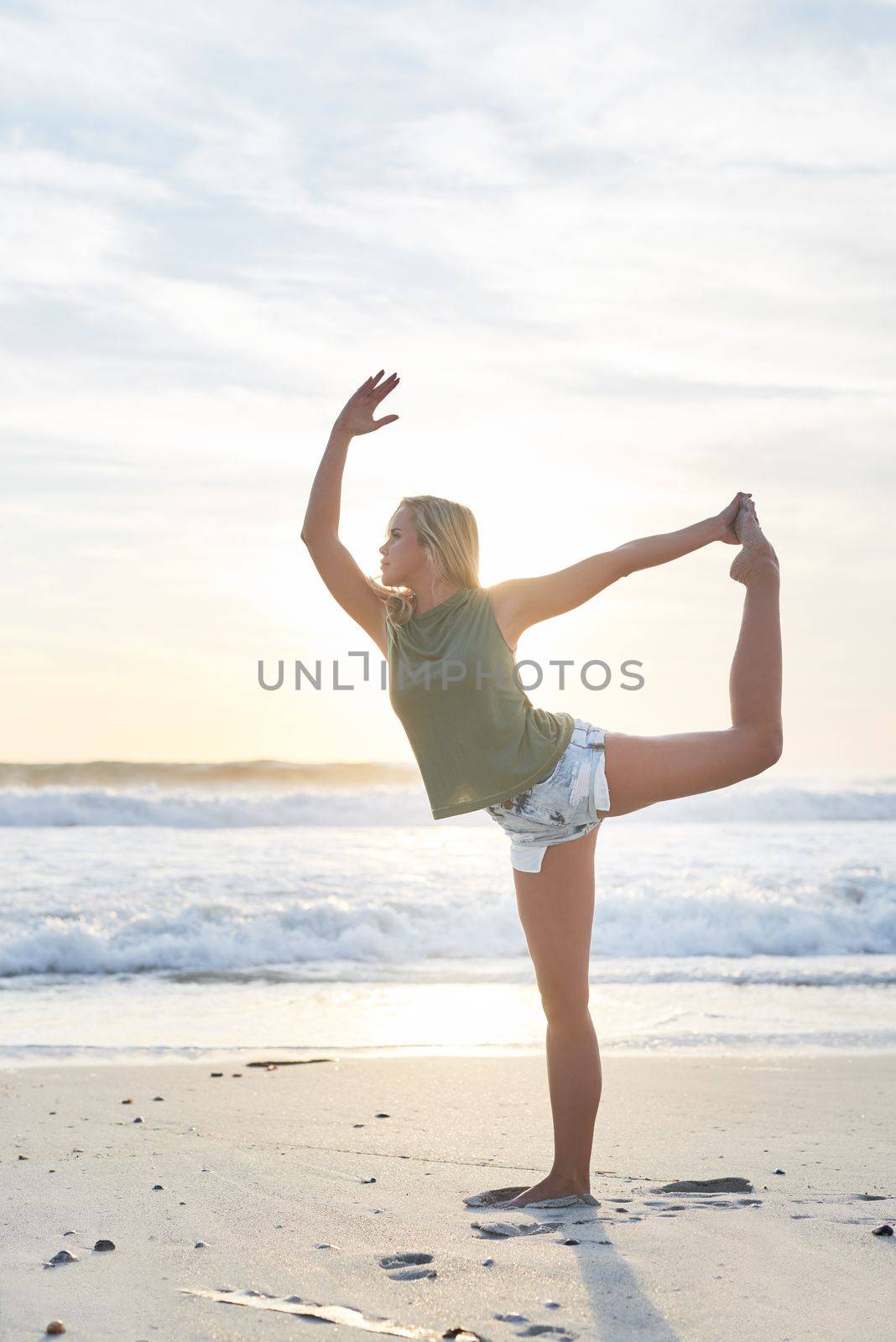 Yoga is what brings me back to me. a young woman practising yoga on the beach