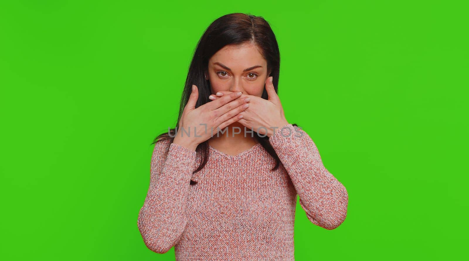 I will not say anyone. Frightened woman closing mouth with hands, looking intimidated scared at camera, gestures no, refusing to tell terrible secret, unbelievable truth. Girl on chroma key background