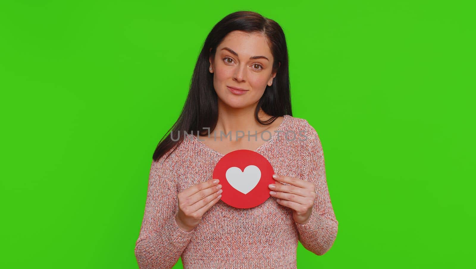 Like. Hipster one pretty woman show heart banner inscription agrees with something, gives positive reply recommends advertisement likes good. Young girl isolated alone on green chroma key background