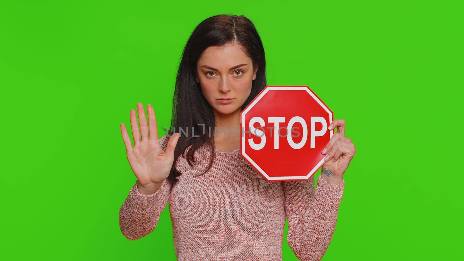 Serious pretty woman say No, hold inscription text red No stop danger sign, warning of finish, prohibited access declining communication, body language, trouble, protest. Girl on chroma key background
