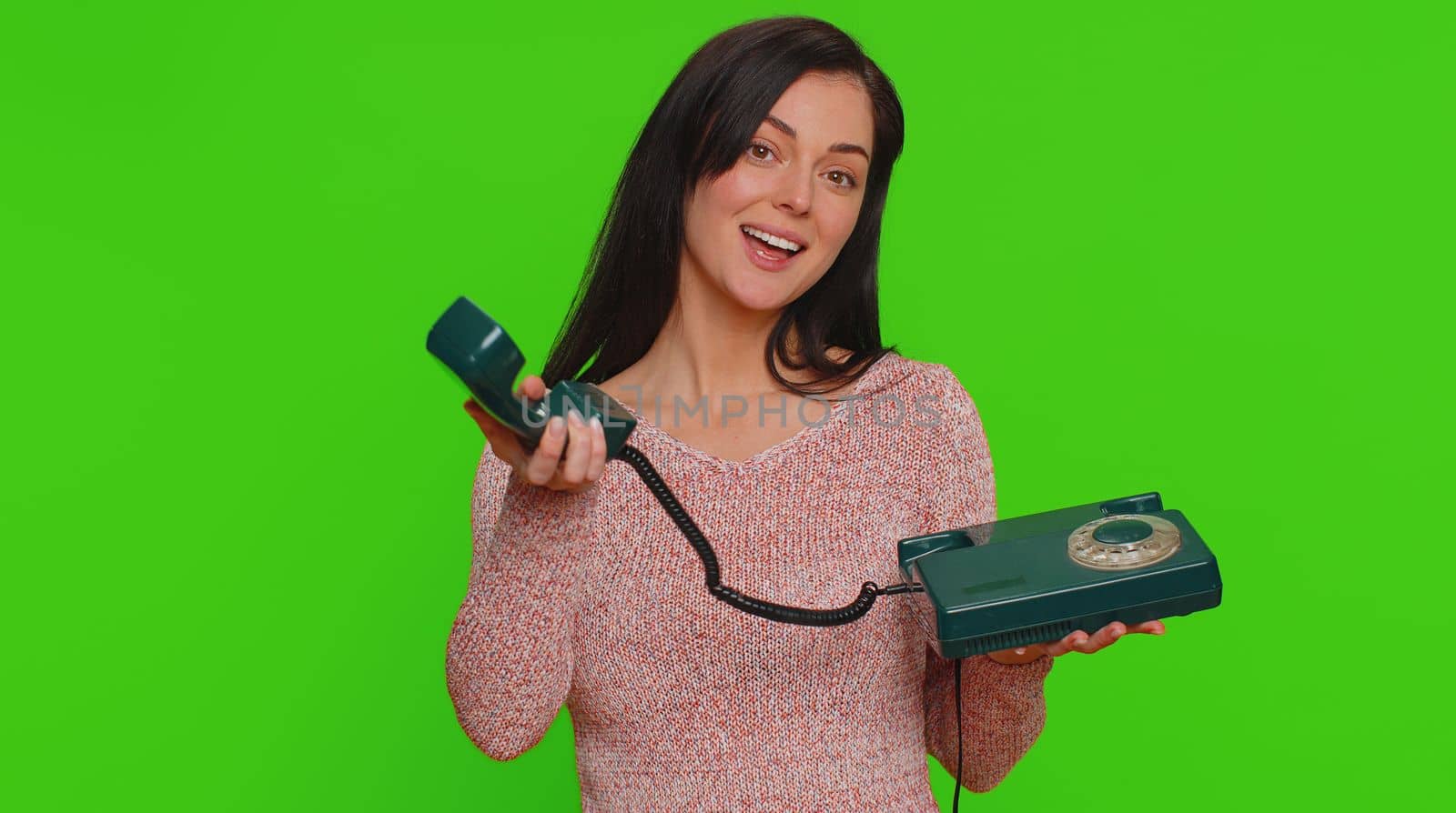 Young woman talking on wired vintage old-fashioned retro telephone of 80s, says hey you call me back by efuror