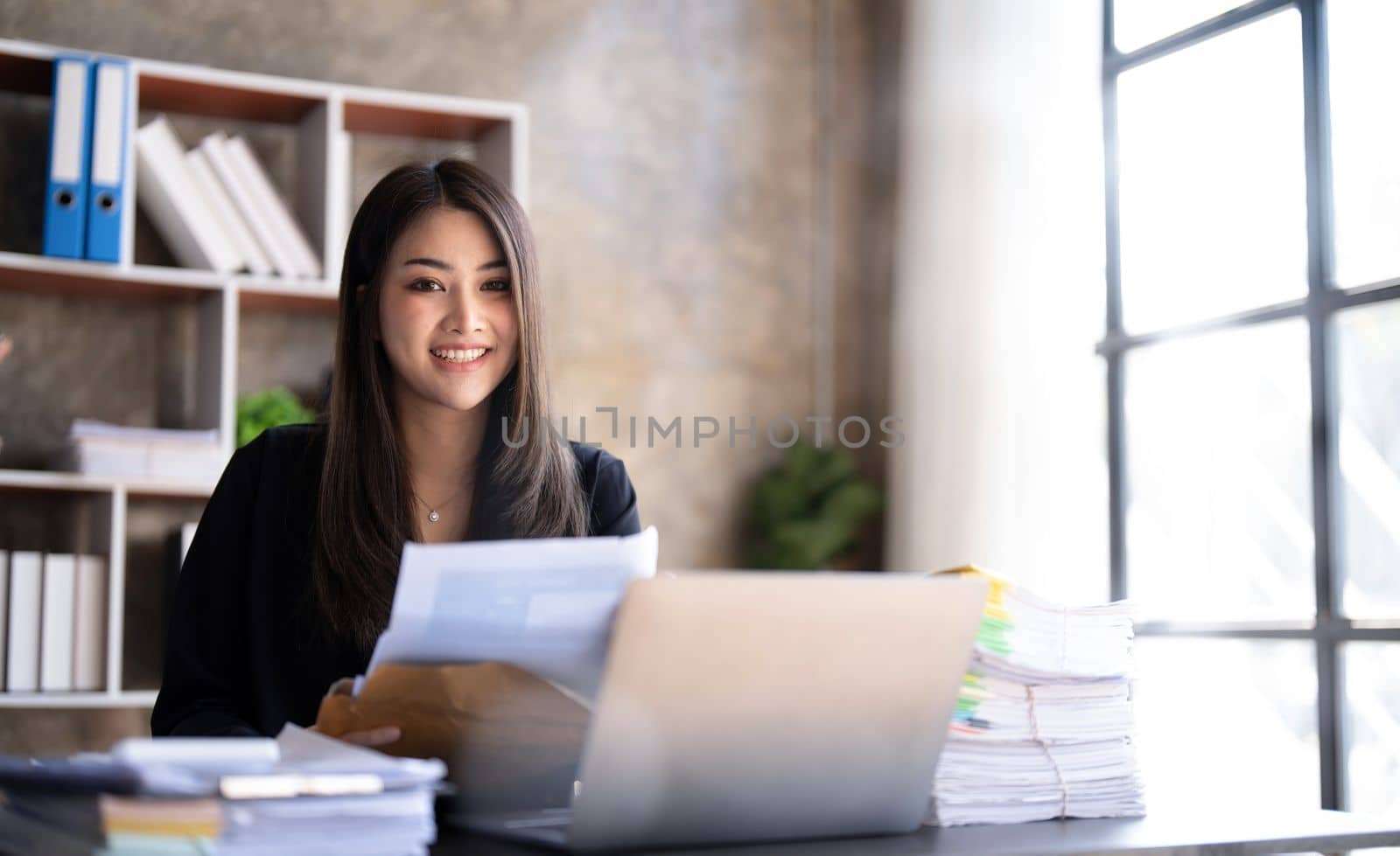 Business woman using calculator for do math finance on wooden desk in office and business working background, tax, accounting, statistics and analytic research concept...