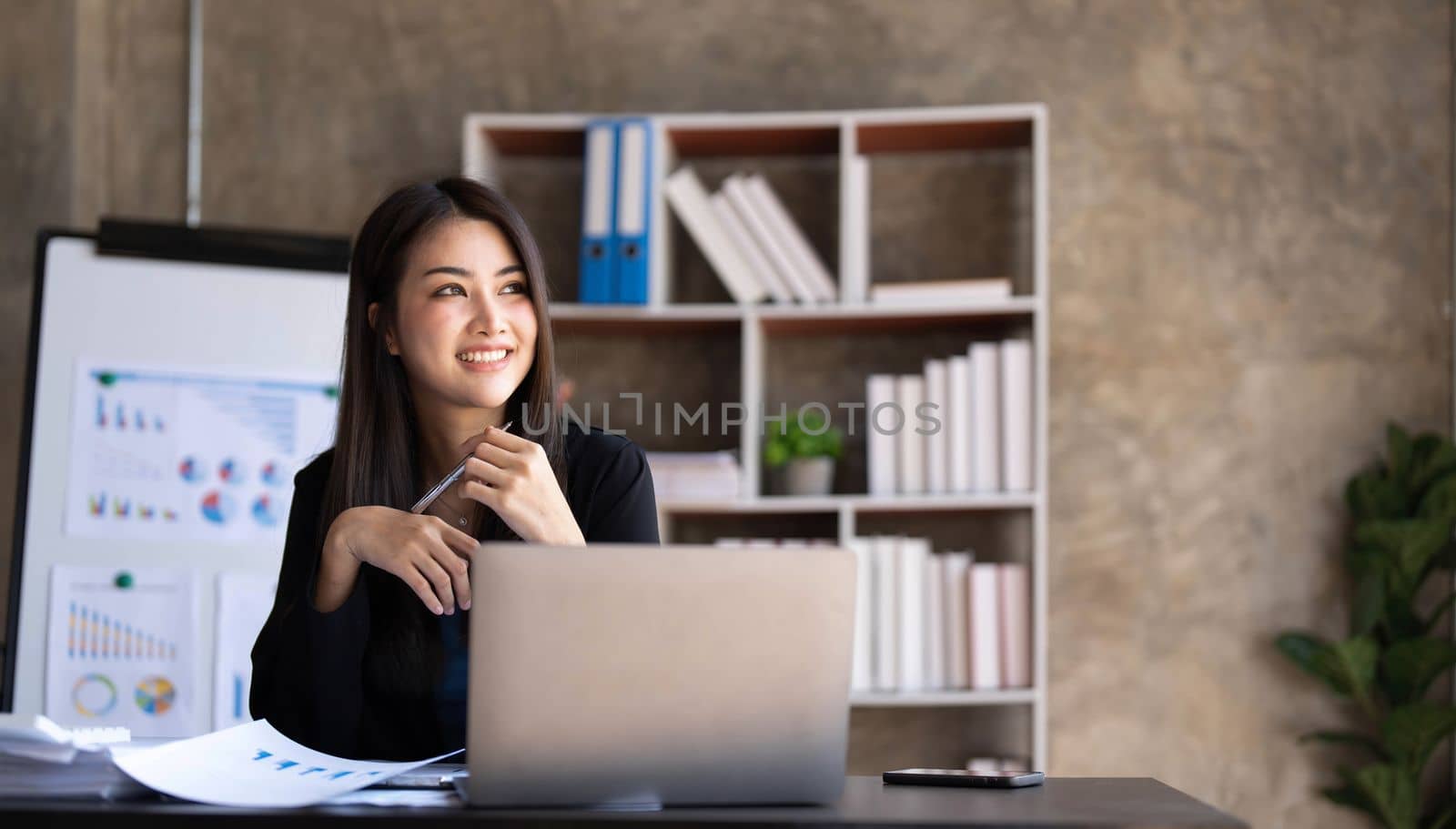 Business woman using calculator for do math finance on wooden desk in office and business working background, tax, accounting, statistics and analytic research concept. by wichayada