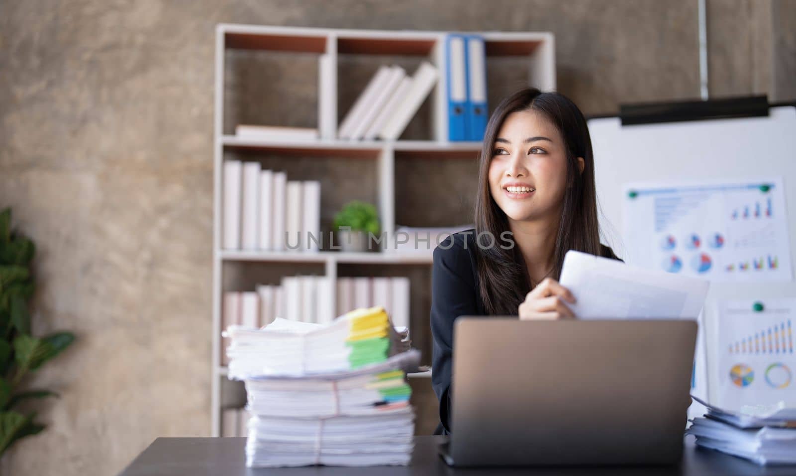 Business woman using calculator for do math finance on wooden desk in office and business working background, tax, accounting, statistics and analytic research concept. by wichayada